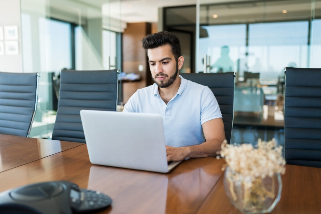 young male professional using technology at office