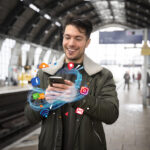 medium shot man holding smartphone